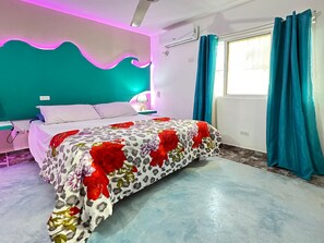 A bedroom with a bed, a nightstand, a lamp, a window with curtains, and an air conditioning unit. - House Jardin Del Caribe (Las Terrenas)