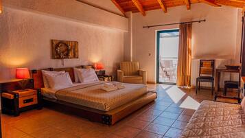 A bedroom with a bed, bedside tables, a chair, and a view of the outside.