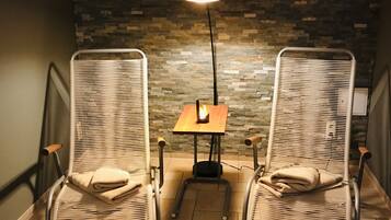 Relax in comfort with two plush armchairs and a table, perfect for conversation or quiet time.