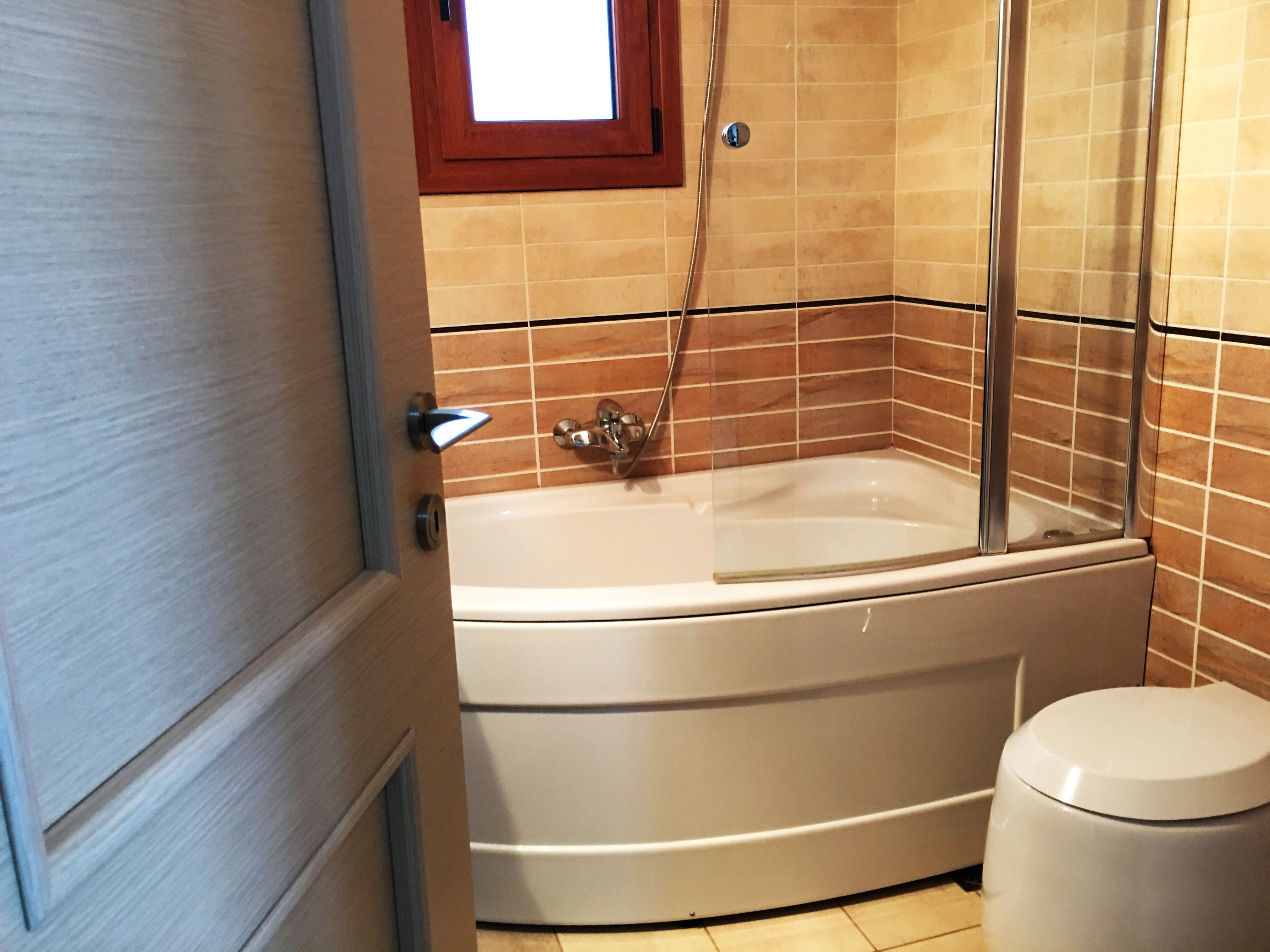 A bathroom with a bathtub, a shower, and a toilet.