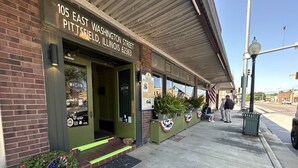 A storefront with a sign reading "105 EAST WASHINGTON STREET PITTSFIELD, ILLINOIS 62363". - William Watson Hotel (Pittsfield)