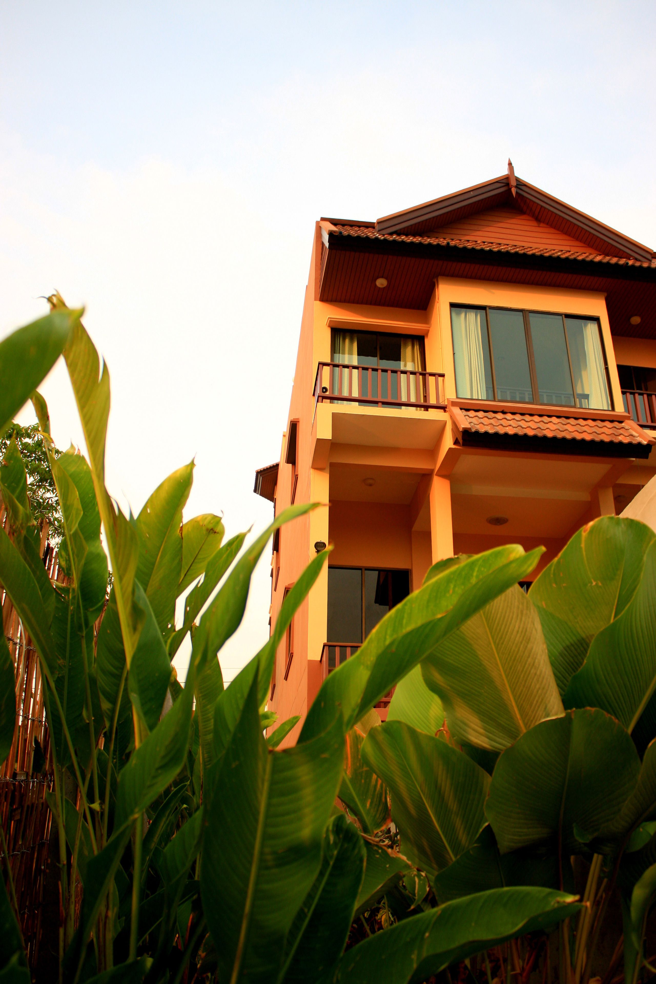 A multi-story building with balconies and large windows.