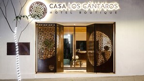 The exterior of Casa Los Cántaros Hotel Boutique with a modern design, featuring patterned doors and a well-lit entrance. - Casa Los Cantaros Hotel Boutique (Oaxaca)