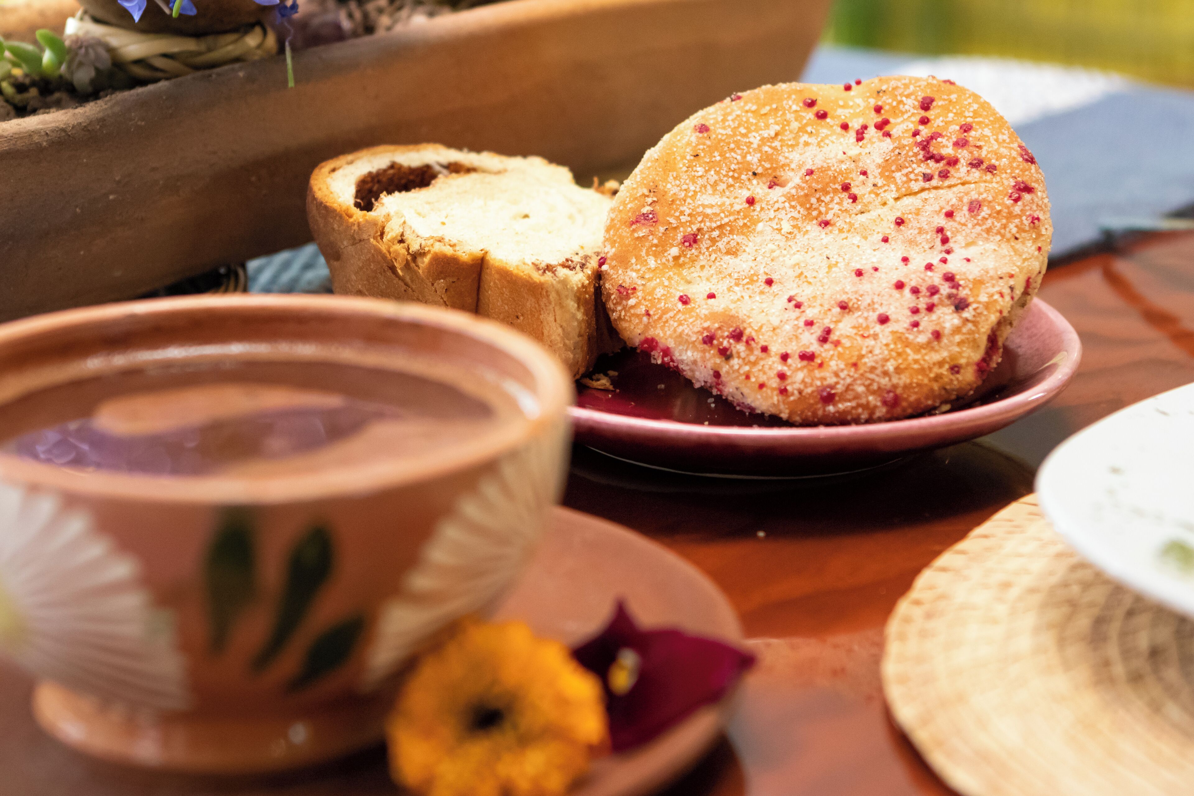 A table with a plate of food, a bowl, and a cup.