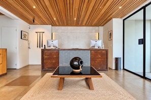 A reception area with a wooden ceiling, two desks with computers, a large decorative sculpture, and a waste bin. - Casa Los Cantaros Hotel Boutique (Oaxaca)