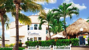 A resort building with a sign reading "Caribbean Resort By The Ocean."