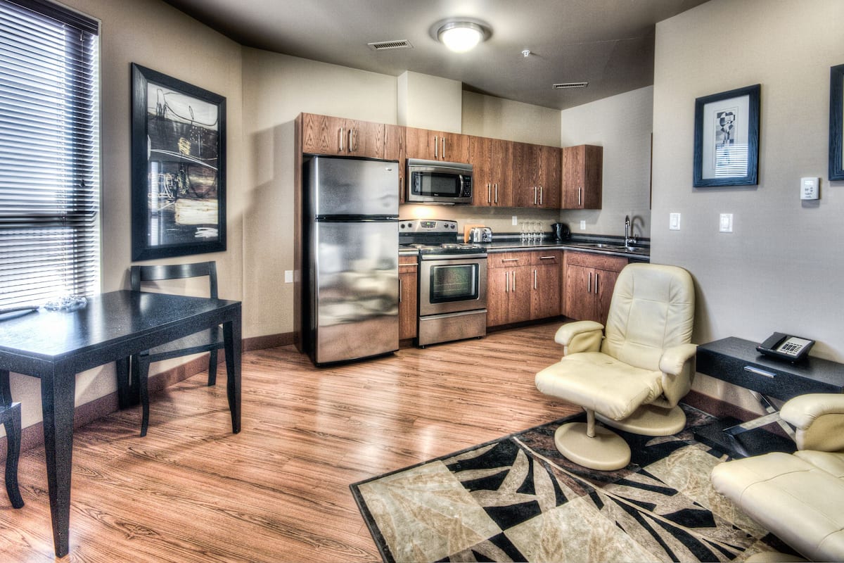 1 bedroom suite with 1 king bed and 1 queen bed, full kitchenette | living area | tv, ipod dock