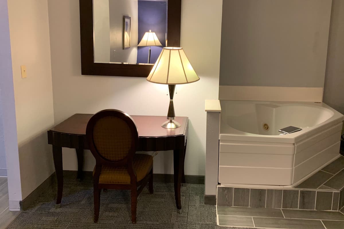 Desk, laptop workspace, blackout drapes, iron/ironing board