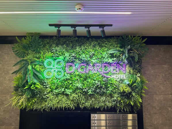A neon sign for 'D'Garden Hotel' with a lush green wall backdrop. - D'Garden Boutique Hotel Kuala Lumpur (Kuala Lumpur)
