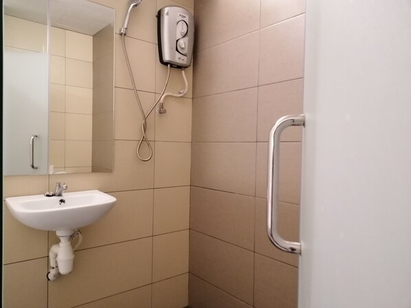 A bathroom with a white sink, a handheld showerhead, and a wall-mounted control panel. - D'Garden Boutique Hotel Kuala Lumpur (Kuala Lumpur)