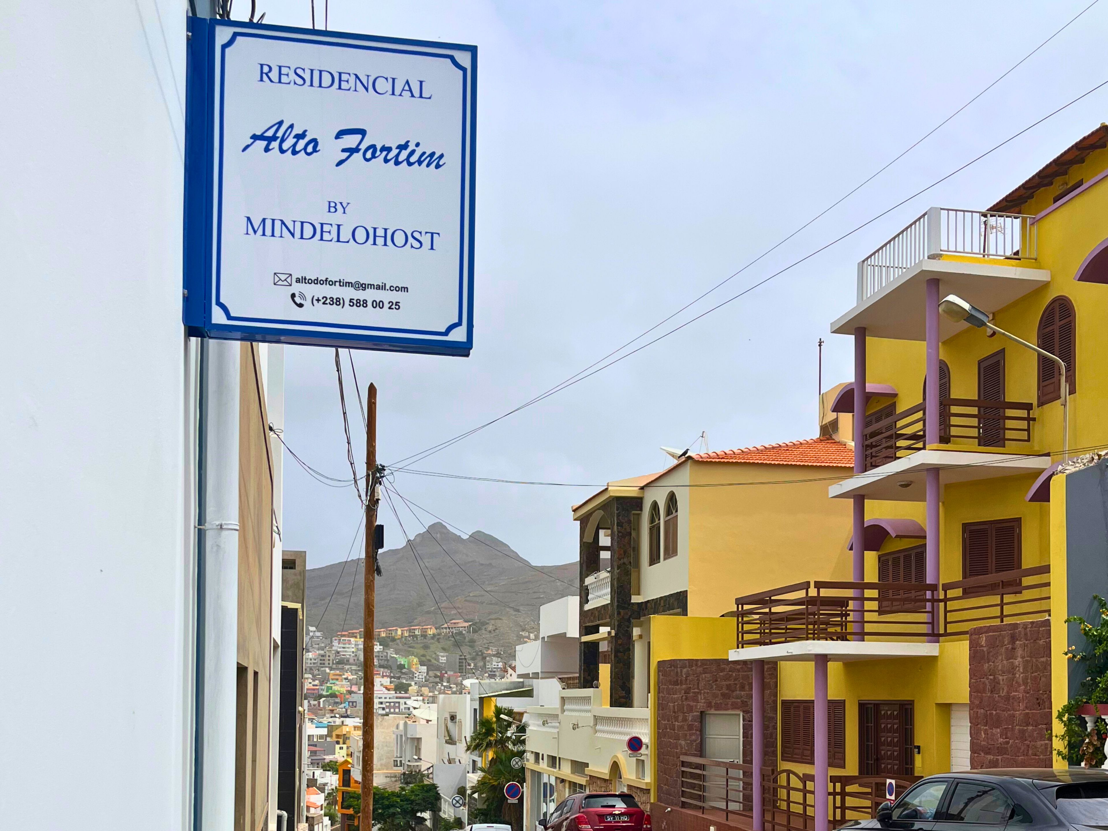 Imóvel residencial chamado Alto Fortim, da MindeloHost, com uma placa de identificação e detalhes de contato.