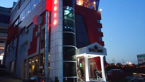 A double-decker bus converted into a hotel with a prominent sign reading "HOTEL ADRIA". - Hotel Adria (Pristina)