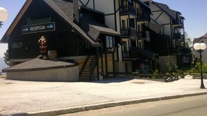 A building with a sign reading "RECEPCIA" and a staircase leading to an upper level. - JollyKop (Raška)