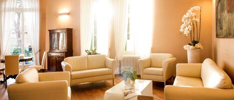 A living room with a sofa set, a coffee table, and a cabinet.