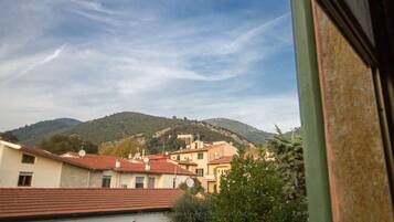 A view of a hillside with buildings, including a church, and a clear sky.