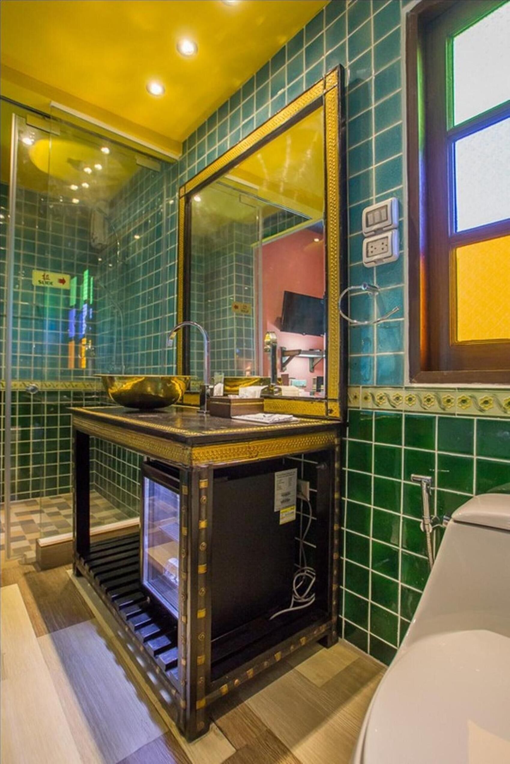 A bathroom with a vanity, mirror, and a sink.