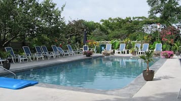 Seasonal outdoor pool, open 8:00 AM to 8:00 PM, pool loungers