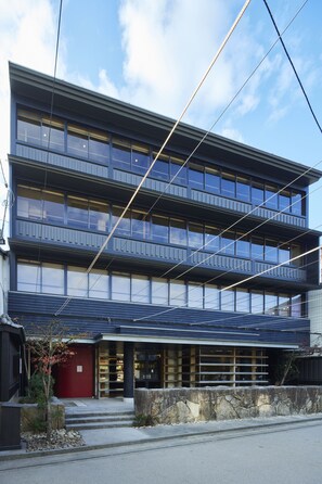A modern multi-story building with large windows and a flat roof. - Itsukushima Iroha  (Hatsukaichi)