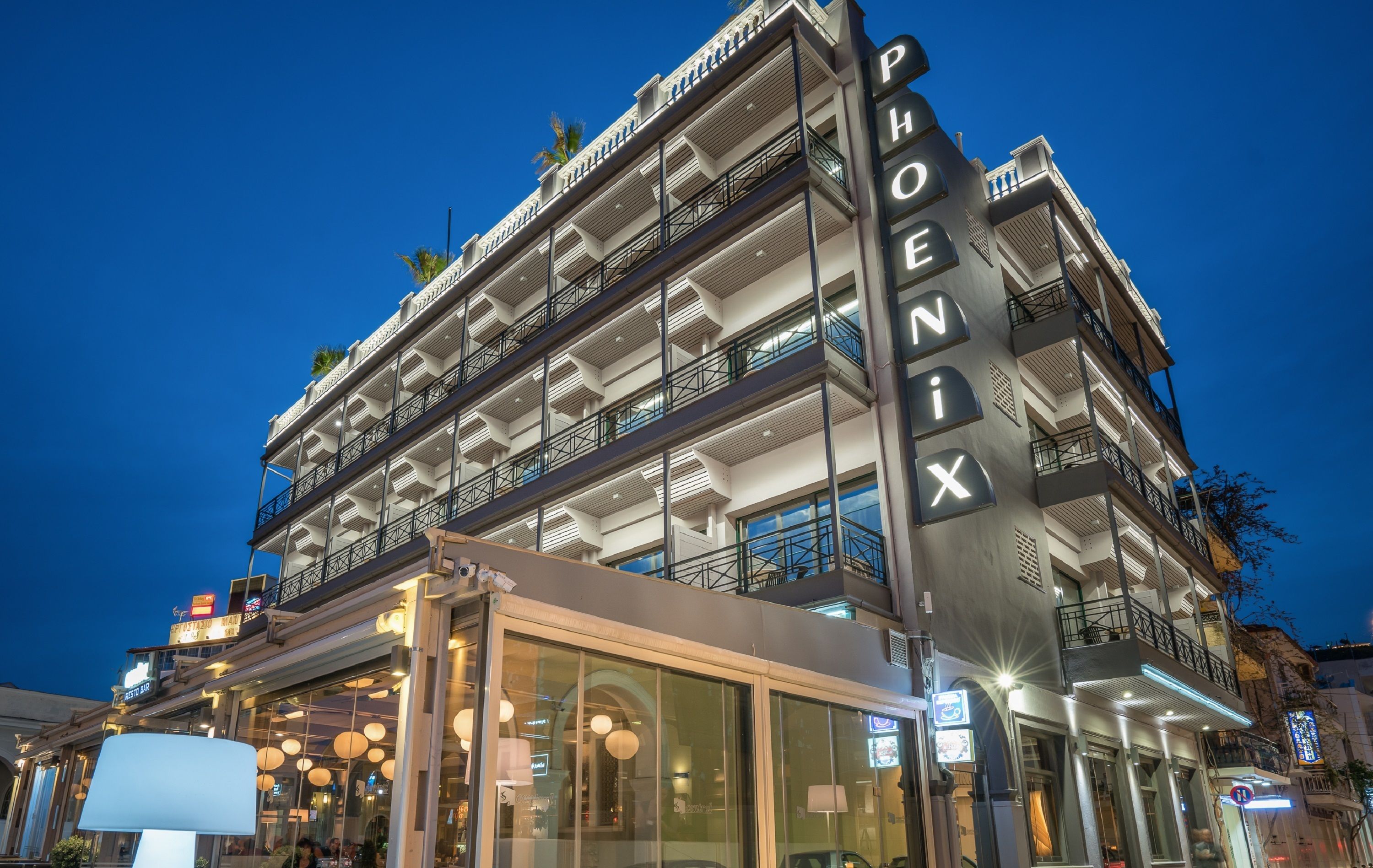 A multi-story hotel with balconies and a prominent sign.
