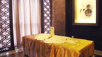 Relax in a traditionally designed room with a neatly arranged bed, framed artwork, and a patterned screen door.