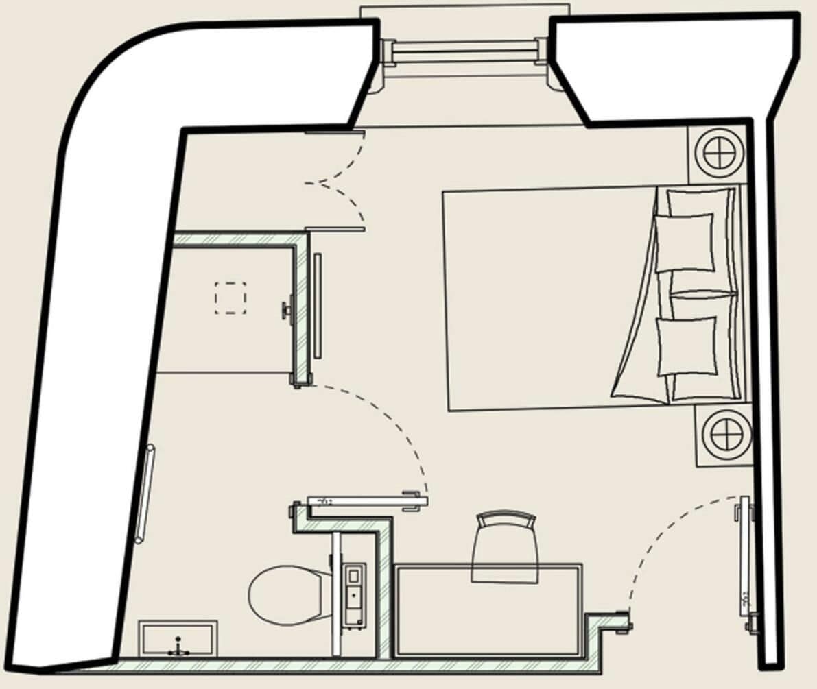 Un plan d’étage d’une chambre d’hôtel comprenant un lit, un bureau, une chaise, une petite table, une armoire et une salle de bain.