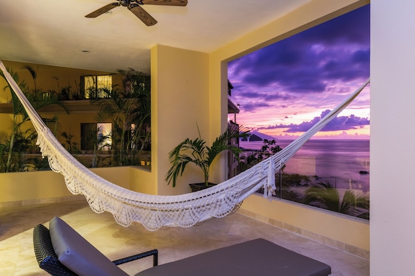 A hammock on a balcony with a view of the ocean at sunset. - Garza Blanca Preserve Resort & Spa - All Inclusive (Puerto Vallarta)