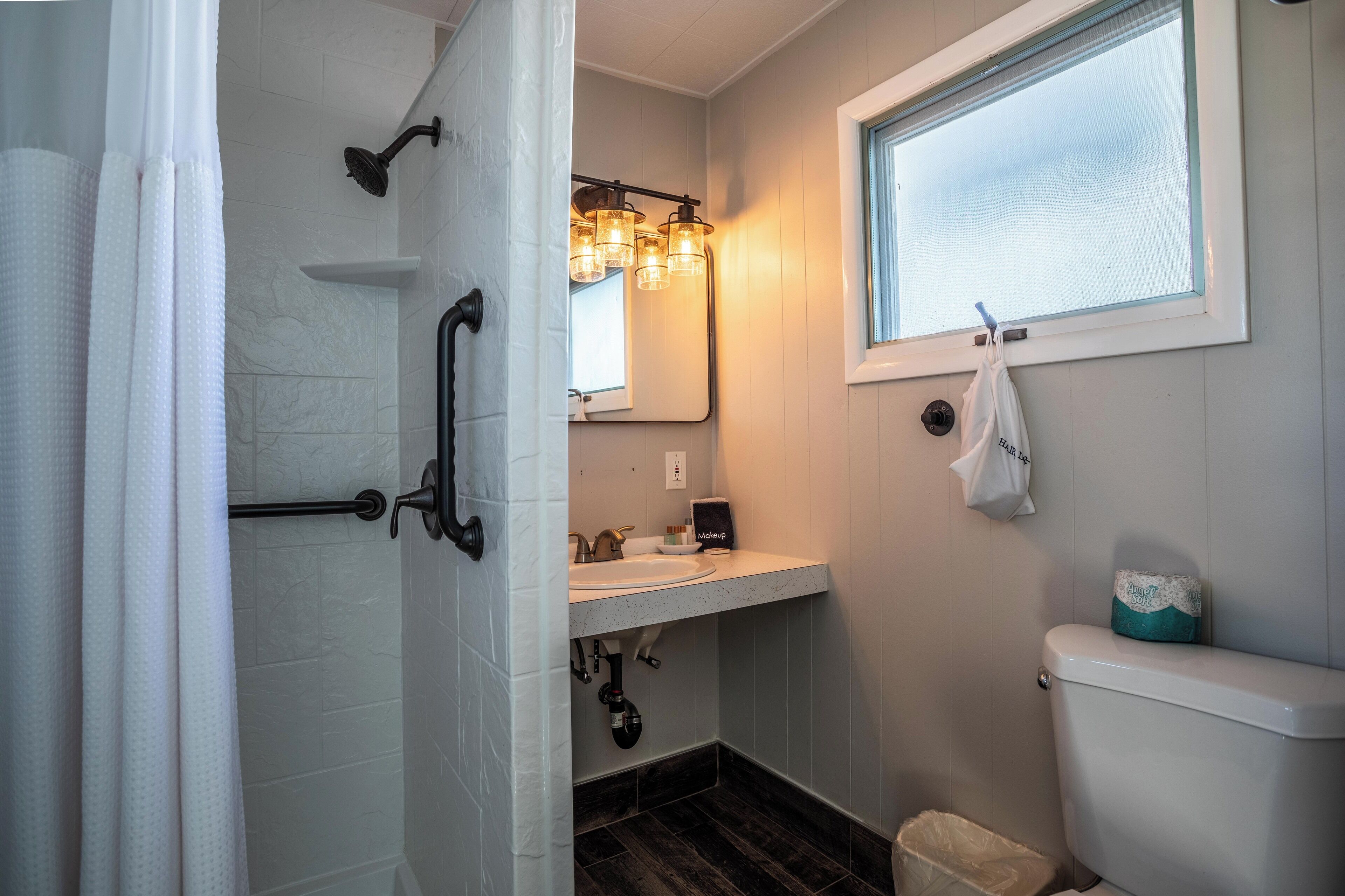 Une salle de bain avec une douche, un lavabo et des toilettes.