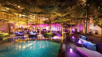 A pool area with lounge seating and a well-lit interior.
