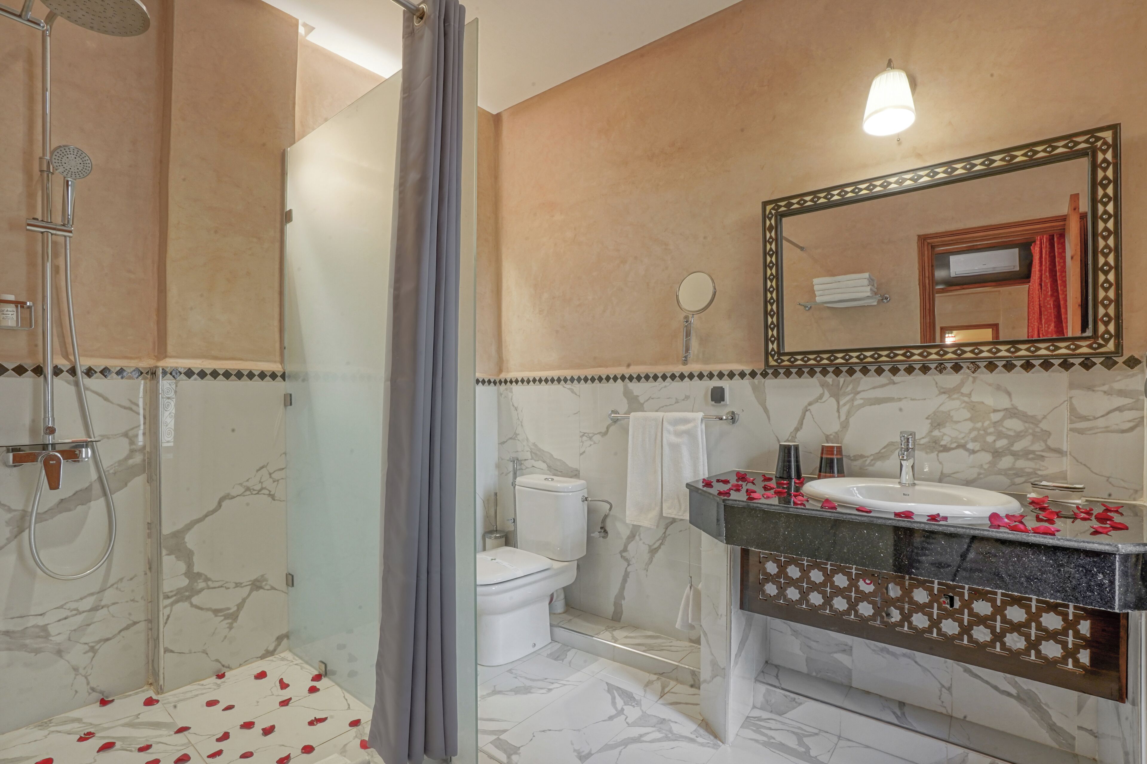 A bathroom with a shower, toilet, and sink.
