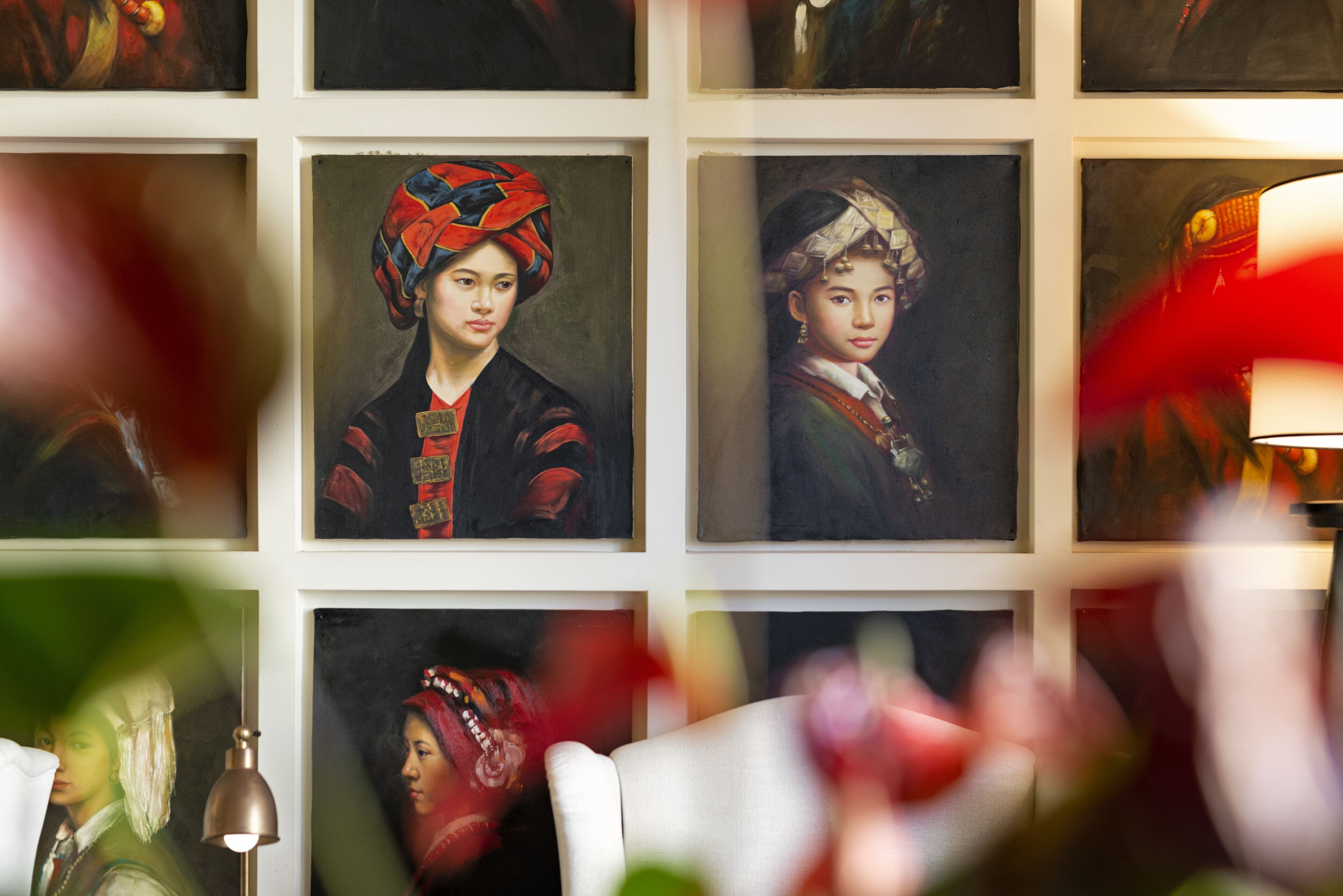 A wall with framed portraits of individuals in traditional attire.