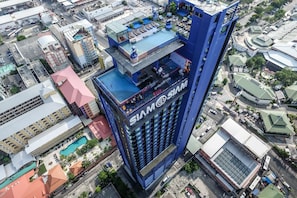 A high-rise building with a prominent 'SIAM' sign, surrounded by other buildings and a pool area. - Siam@Siam Design Hotel Pattaya (Pattaya)