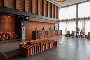 A modern lobby with a reception desk, seating areas, and a large window. - Siam@Siam Design Hotel Pattaya (Pattaya)
