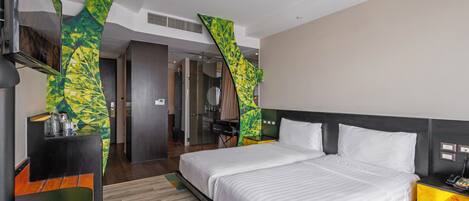 A hotel room with a bed, a desk, and a TV.