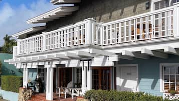 Stunning two-story home with a spacious balcony and charming front porch.