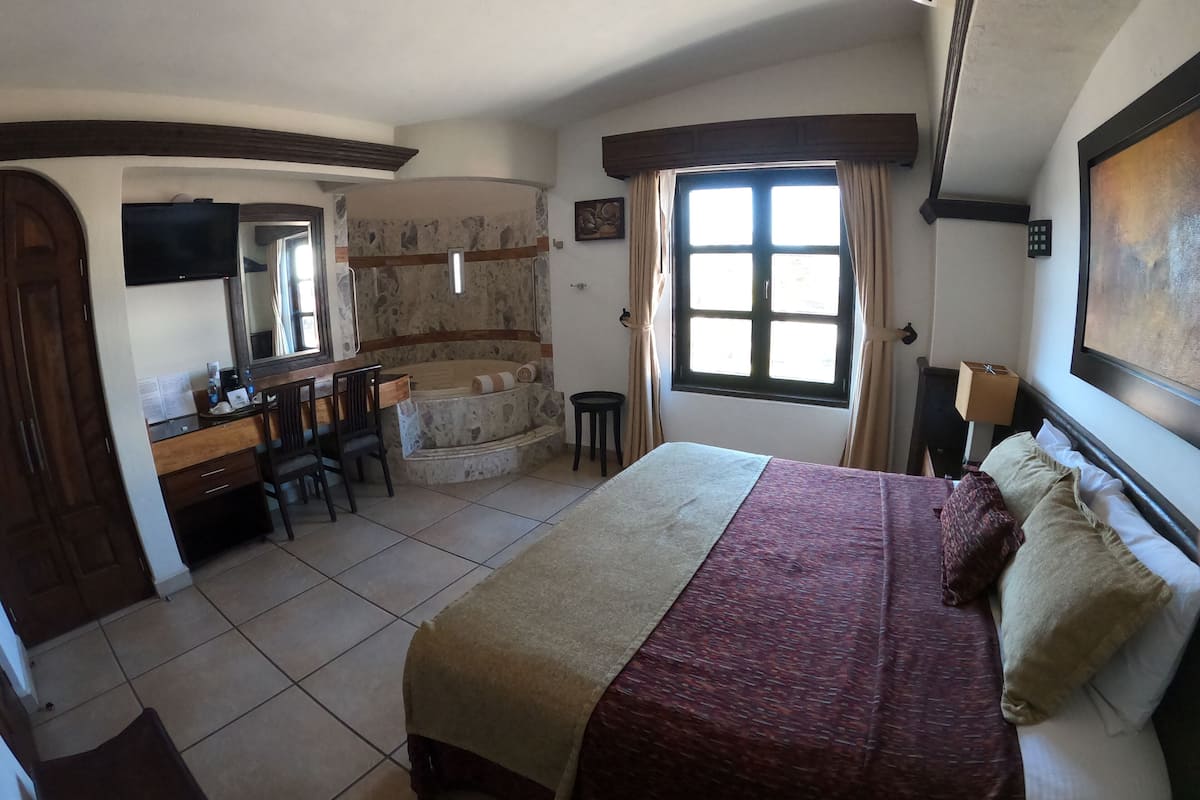 junior suite, hot tub | in-room safe, desk, iron/ironing board, bed sheets