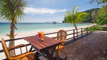 Relax on the deck with a view of the turquoise waters and a glimpse of a nearby island.