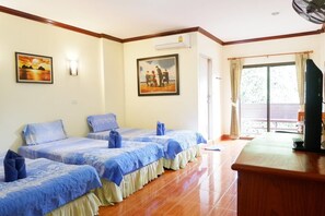 Two single beds with matching bedding, a desk, and a television.