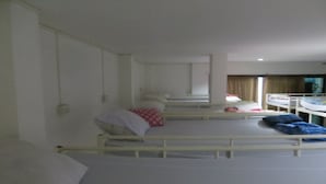 A hospital room with multiple beds, each with pillows and blankets. - Lucky House Dorm Room - Hostel (Ko Phi Phi)