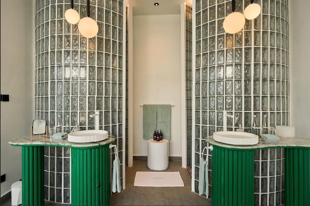A bathroom with two sinks, a mirror, and a towel rack.