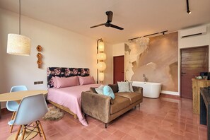 Ein modernes Schlafzimmer mit Bett, Sofa und Schreibtisch.
