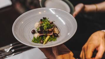 A person holding a plate of food.