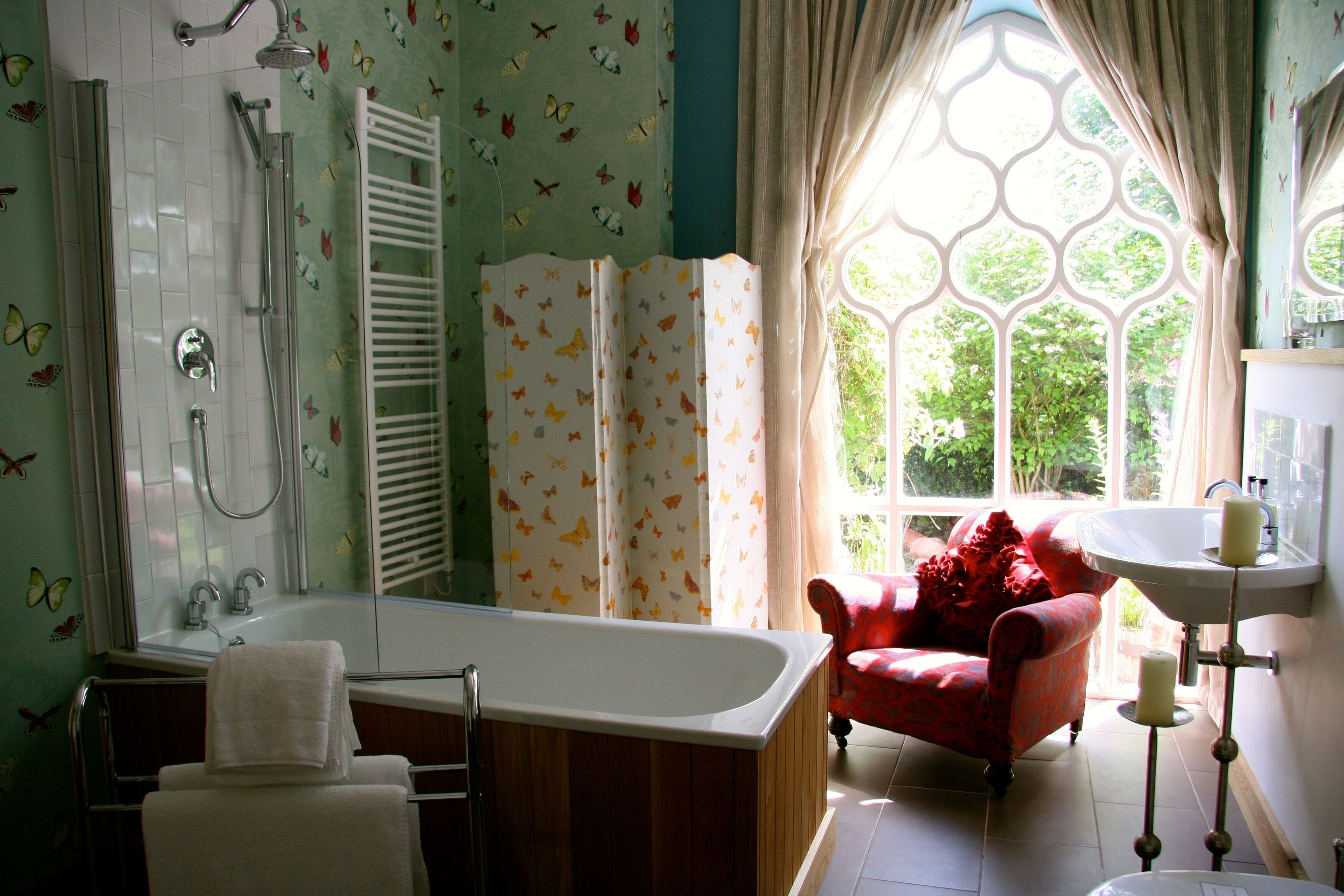 A bathroom with a bathtub, shower, and sink.