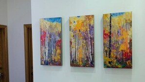 Three abstract paintings on a white wall in a hallway. - Regency Hotel Parkside (London)