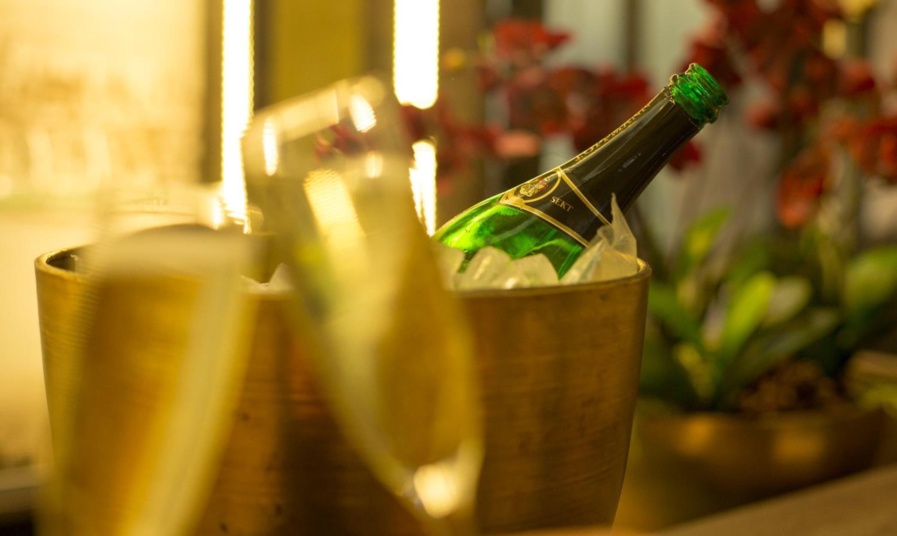 Eine Flasche Champagner in einem goldenen Eimer.