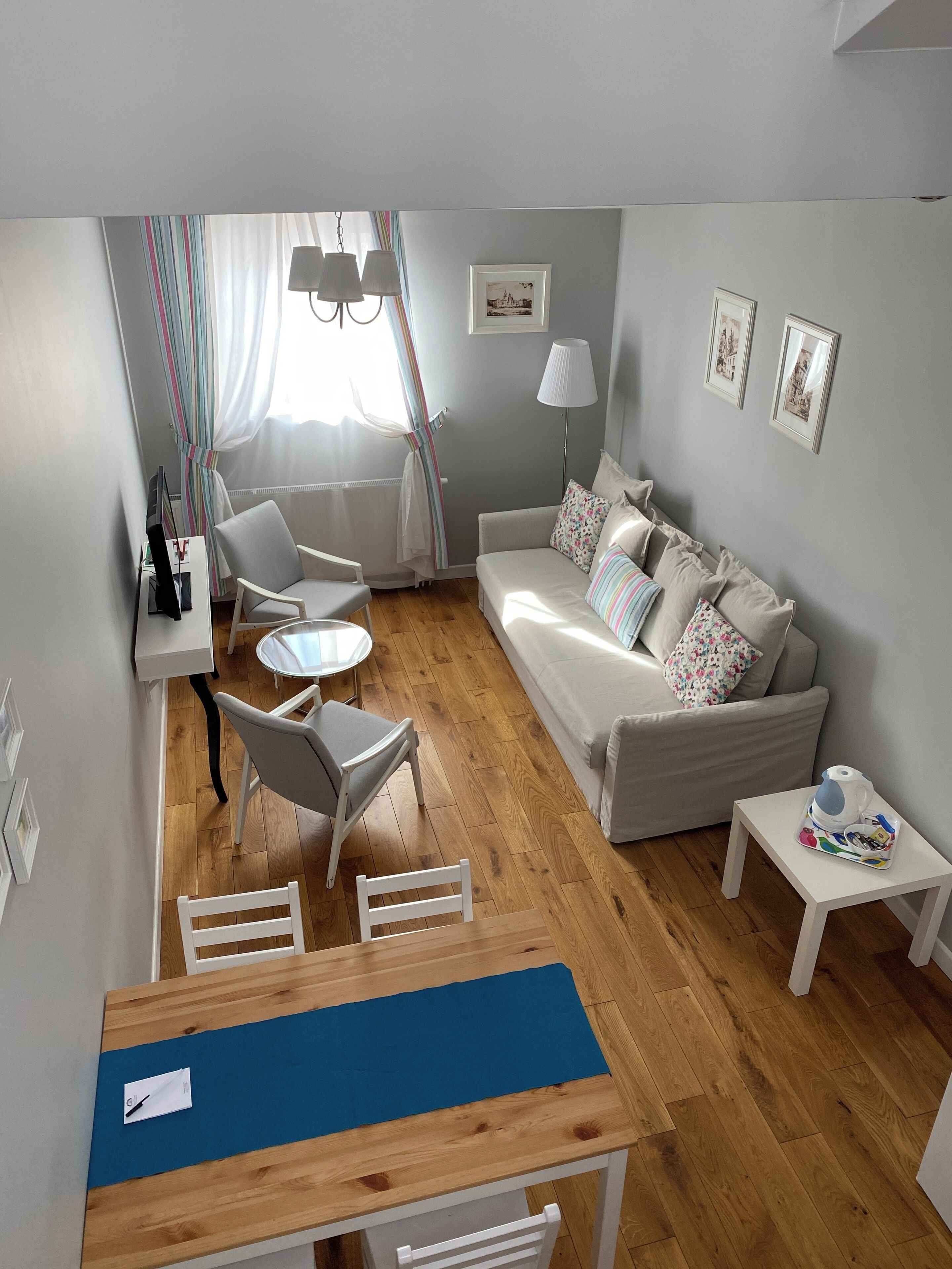 A cozy living room with a sofa, chairs, a small table, and a coffee table.