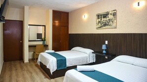 A hotel room with two beds, a wooden wardrobe, a desk with a chair, and a wall-mounted picture. - Hotel U Xul Kah (Campeche)