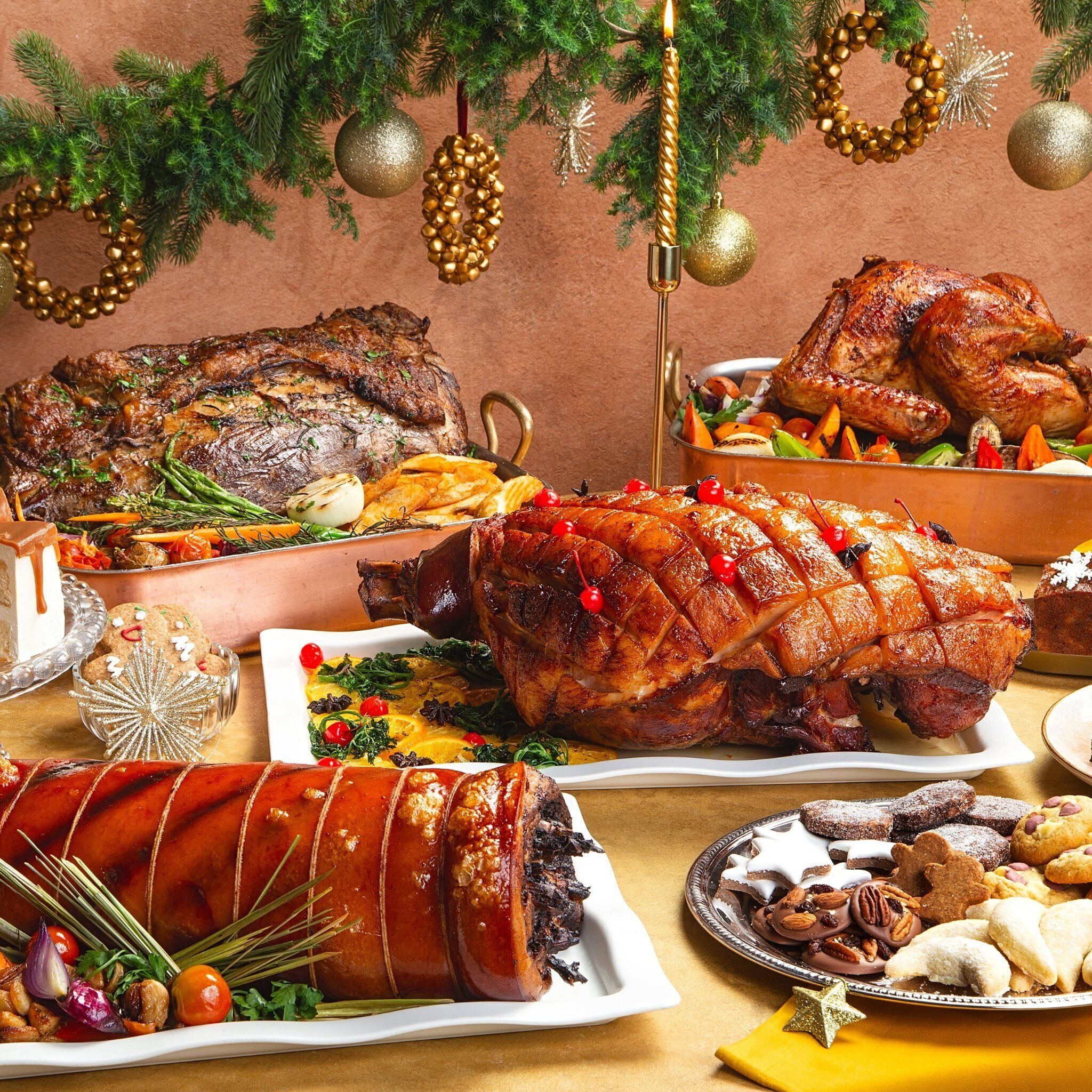 A festive meal with roasted meats, vegetables, and various desserts.