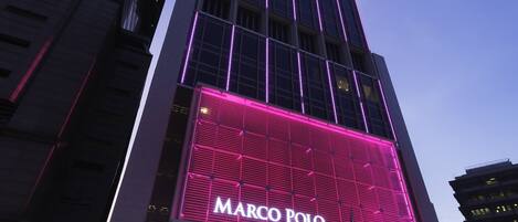 A tall building with a prominent 'Marco Polo' sign on the facade.