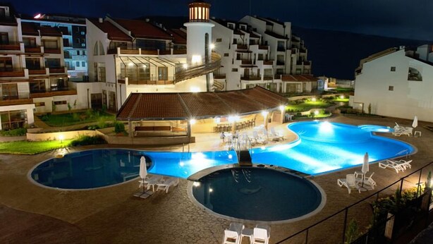 A resort with a swimming pool area, a covered seating area, and a lighthouse. - Aparthotel Lighthouse (Sveti Vlas)