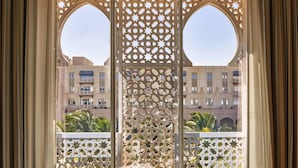 A view through a window with intricate geometric patterns and two large circular openings. - Salalah Gardens Hotel Managed by Safir Hotels & Resorts  (Salalah)